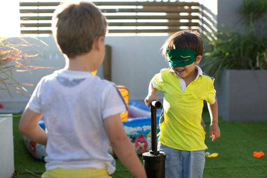 Child pump inflates balloons at a kid's birthday party.