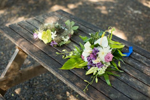 wedding bouquet and wreath on a wooden table