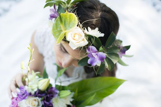 Beautiful young bride in a wreath with a bouquet in hand