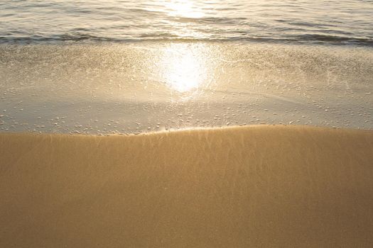 Sandy beach of the Indian Ocean at sunset.