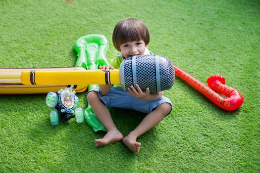 Boy with inflatable microphone at a children's birthday party.