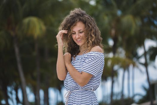 Beautiful girl on a background of palm trees