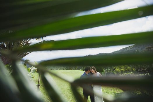 young loving happy couple on tropical island with palm trees