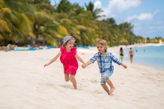 kids having fun running together in the beach