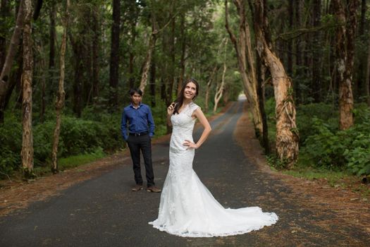 Walking the young bride and groom in the woods