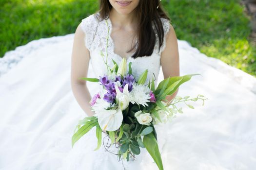 Beautiful young bride in a wreath with a bouquet in hand