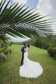 young loving happy couple on tropical island with palm trees
