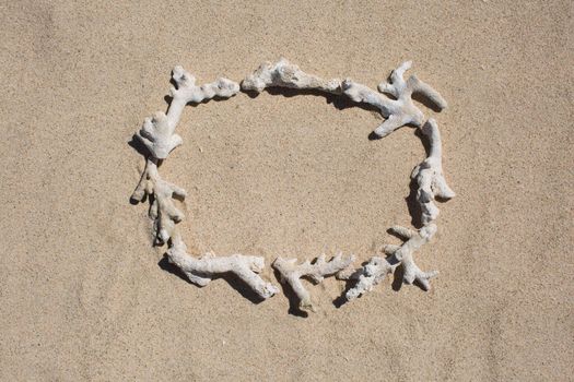 Frame of inscription of coral debris on the sand.