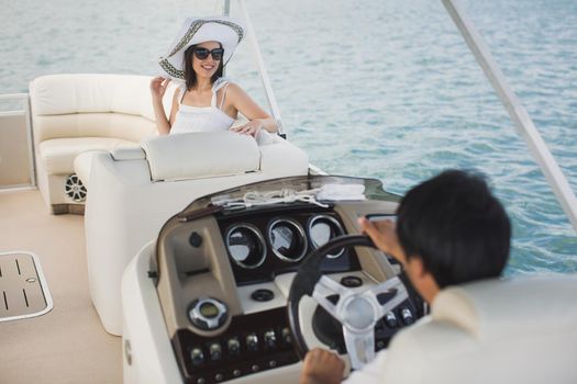 Young couple navigating on a yacht in Indian ocean