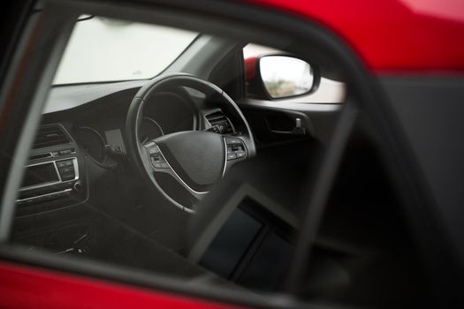 Interior view of car with black interior through the glass.