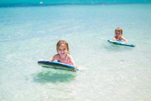 Twins brother and sister to have fun with surfing in the ocean