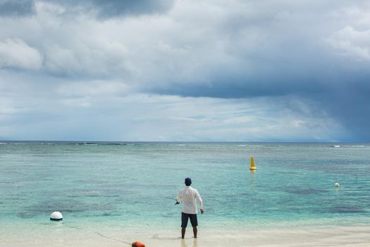 Fishing on the beach on the ocean.