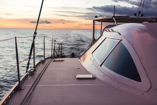 Sailing ship luxury yacht boat in the Sea during amazing sunset.