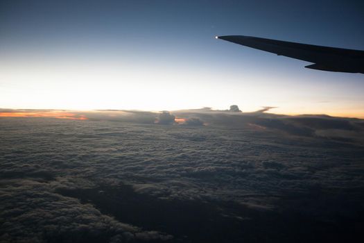 View of the sunrise and clouds through the porthole.