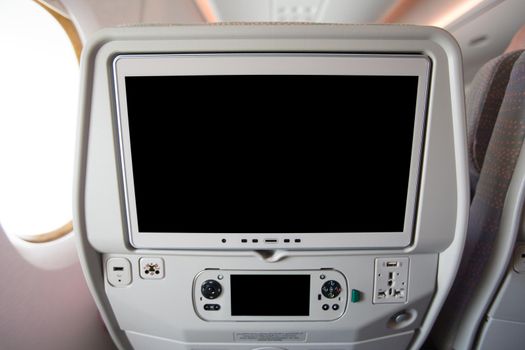 Airplane seat back, LCD screen, entertainment during the flight.