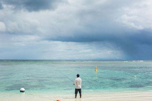 Fishing on the beach on the ocean.