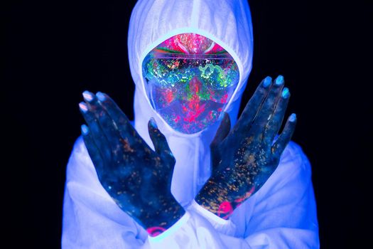 Doctor in ultraviolet neon light wearing protection suit and face mask show sign gesture stop no pandemic epidemic of Covid-19, Coronavirus