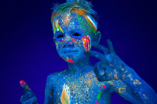 Portrait of a neon baby boy, shows class and super in UV light