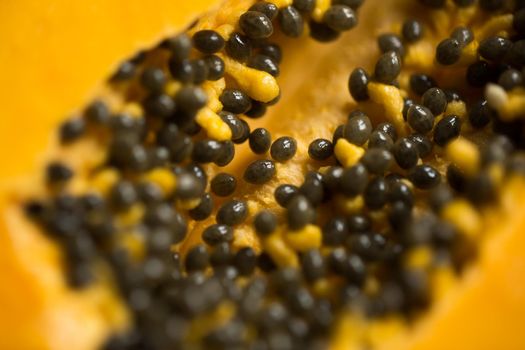 A close-up cut of a sweet yellow papaya.