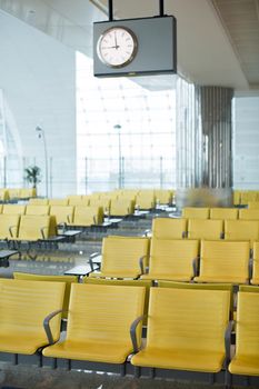 Bench in the terminal of airport. empty airport terminal waiting area with chairs.