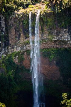 Waterfall flows into the crater of the volcano in Mauritius. National Park Chamarel.