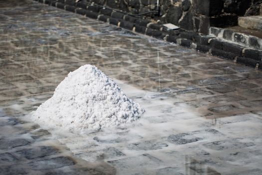 Fields of salt on the shores of the Indian ocean in Mauritius. The collection of salt.