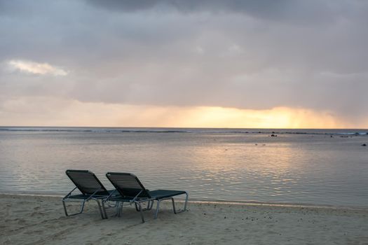 beach chair on the beach with sunset