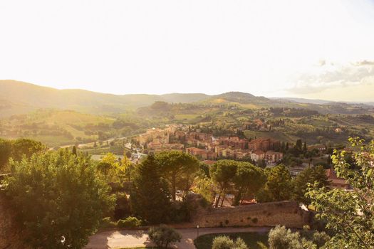 Aerial view of the broad Tuscan countryside and villages at sunset, from the town of San Gimignano, Italy. High quality photo.
