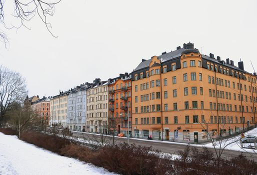 Vibrant, colourful Swedish apartment buildings in the winter snow, Ostermalm, Stockholm, Sweden. High quality photo.