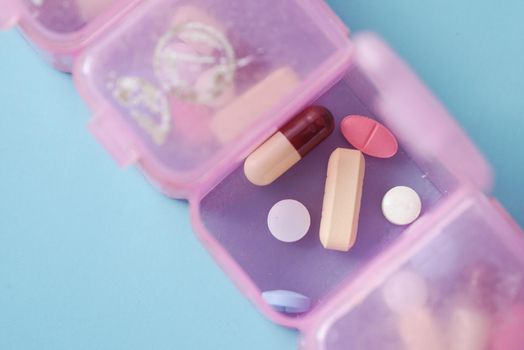 top view of medical pills in a pill box on color background ,
