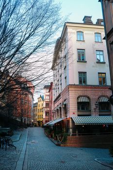 Decorated street corner restaurant and coloured buildings at Christmas, in 'Gamla Stan', Stockholm, Sweden. High quality photo.