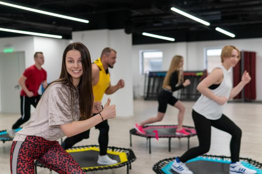 Women's and men's group on a sports trampoline, fitness training, healthy life - a concept trampoline group batut instructor men, for lifestyle athletic from fitness from young body, sportive sportswear. Many bodycare athlete, aerobic