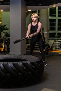 Wheel with sledgehammer girl stands tire active fitness, In the afternoon equipment training from workout athlete health, activity muscle. Posing male lights, standing