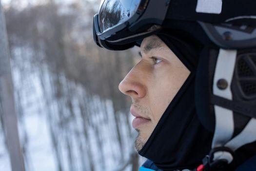 ski resort man portrait on chairlift in helmet and mask. High quality photo