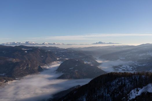 mountain peaks covered with snow and foggy valley. High quality photo