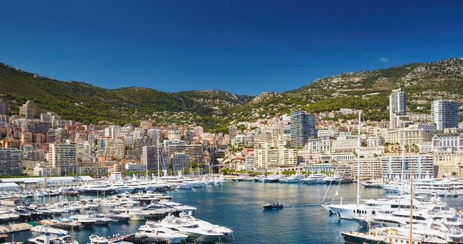 Aerial view of port Hercules in Monaco - Monte-Carlo at sunny day, a lot of yachts and boats are moored in marina, mediterranean sea. High quality photo