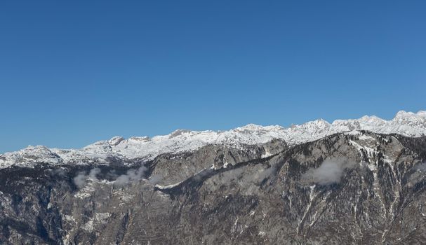 mountain peaks covered with snow over grey rocks. High quality photo