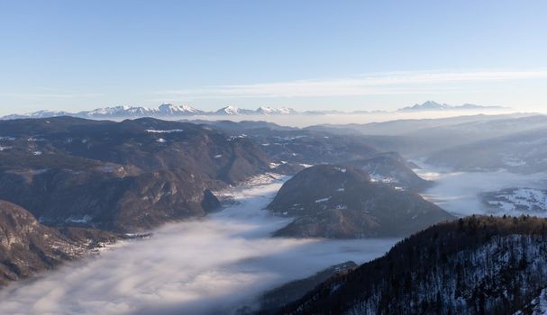 mountain peaks covered with snow and foggy valley. High quality photo