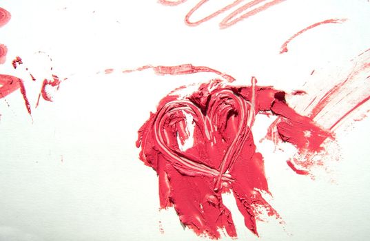 Smeared spots of red lipstick stand out against a white background. Creamy texture of makeup. Cosmetic product concept.
