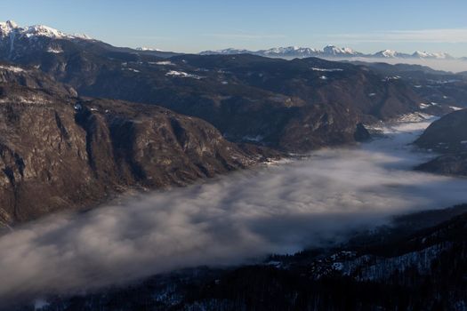 mountain peaks covered with snow and foggy valley. High quality photo