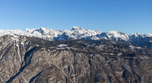 mountain peaks covered with snow over grey rocks. High quality photo