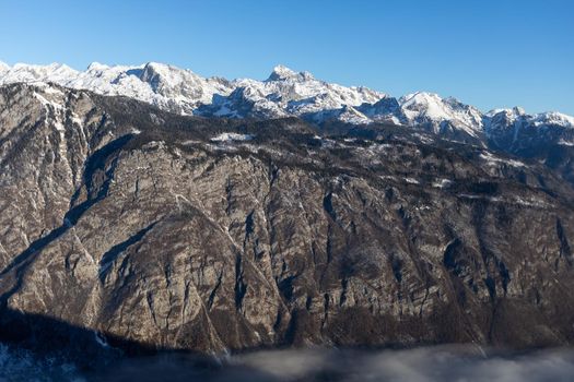 mountain peaks covered with snow over grey rocks. High quality photo