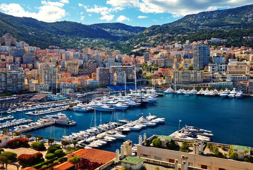 Aerial view of port Hercules in Monaco - Monte-Carlo at sunny day, a lot of yachts and boats are moored in marina, mediterranean sea. High quality photo