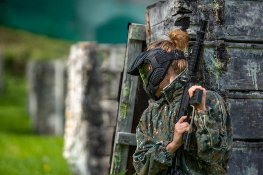 woman in action while playing paintball.