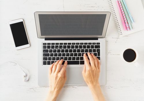 Work from home, online shopping, learning. White desk, old table. Top view. Distance education. Woman hands typing on laptop. Freelancer, Digital nomad concept