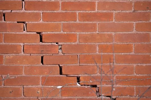 Red Brick Wall with Large Crack and crumbling mortar. High quality photo