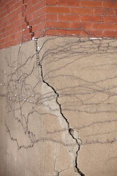 Foundation with Large Crack that extends into the brick wall above it. High quality photo