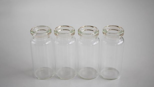 Empty glass bottles for storing medicines, liquids on a white background.