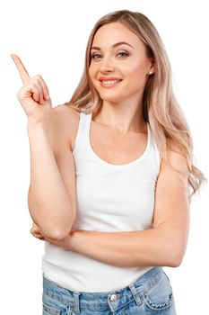 Young woman pointing at your product isolated on white background, close up