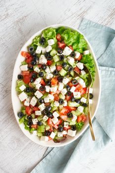 Greek salad Horiatiki with feta cheese, olives, tomato, cucumber, lettuce, vegeterian mediterranean food, low calories dieting meal